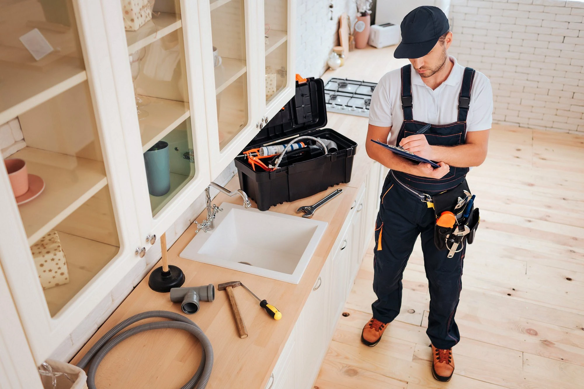 Handyman making notes about potential repairs at a jobsite.