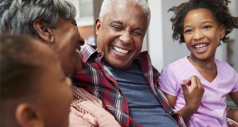 African American grandparents with grandchildren laughing