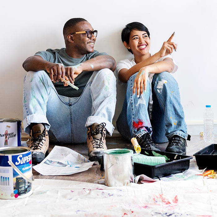 Young Couple Painting Home