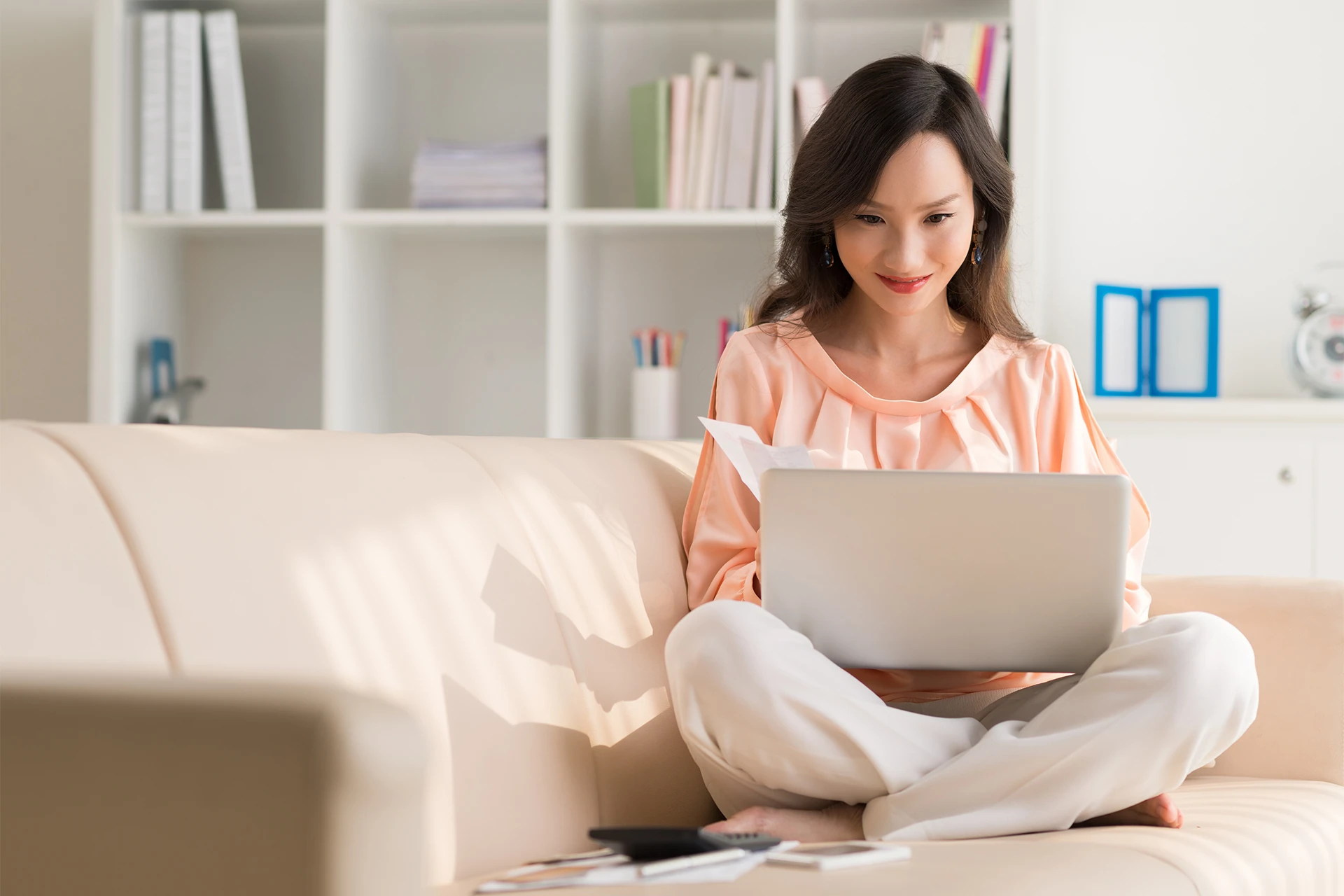 Woman using laptop on couch