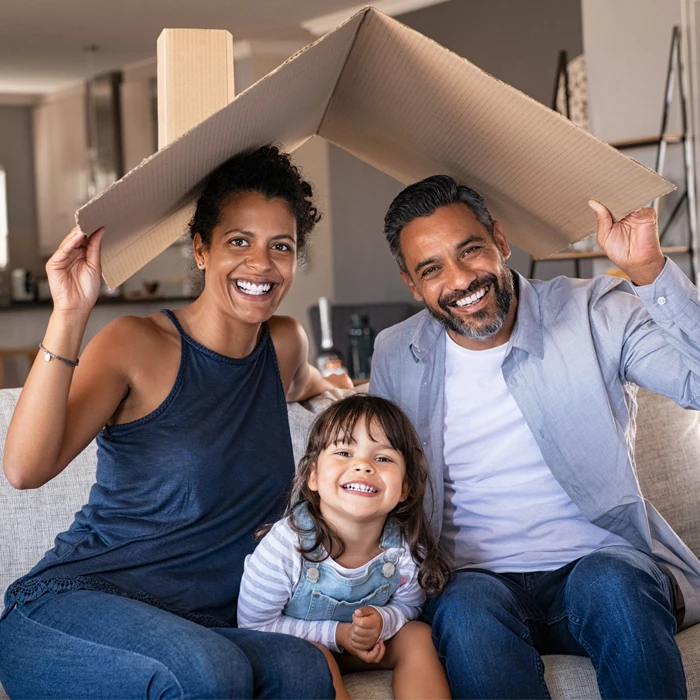 family holding make-shift roof over their heads