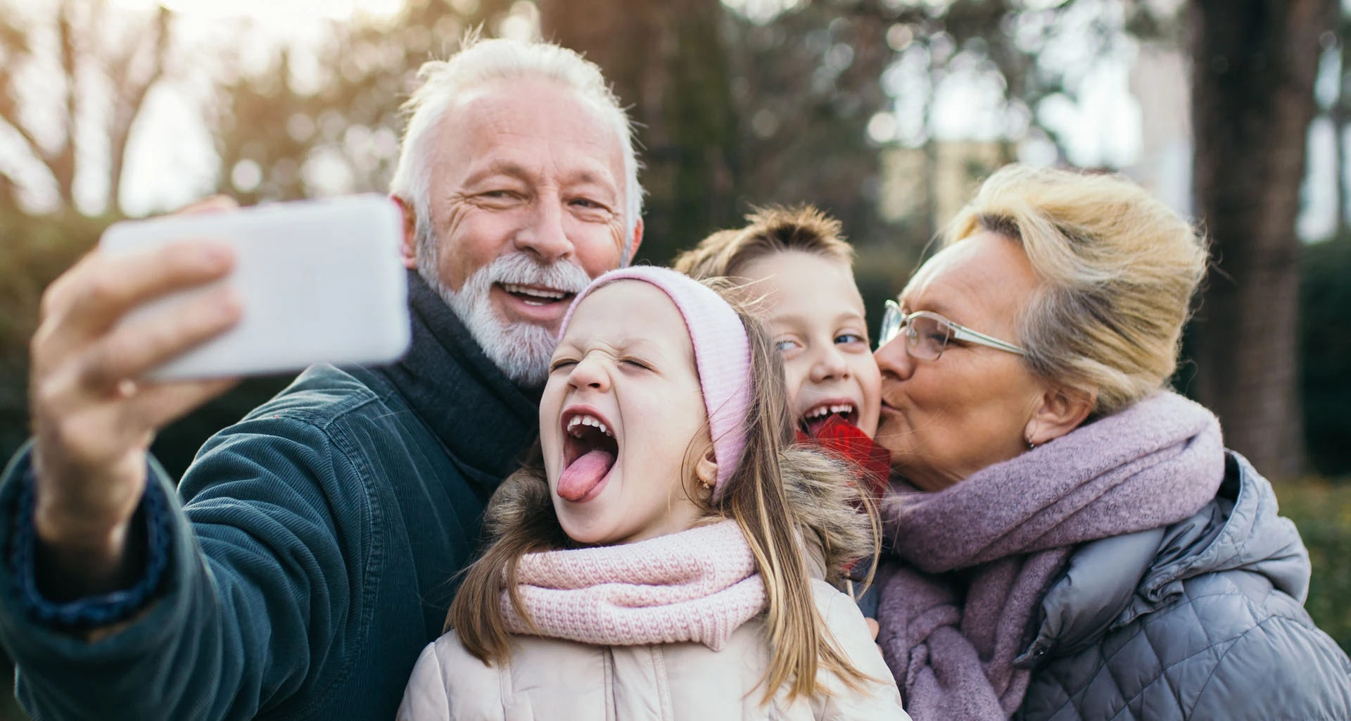 Grandparents taking cell phone pic with grandchildren