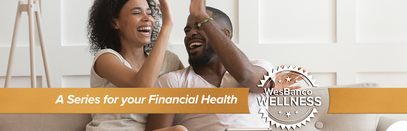 A young couple cheerfully high-five each other while sitting on a couch. The words A Series for your Financial Health in orange banner in the foreground.