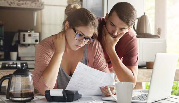 couple pensively reviews documents