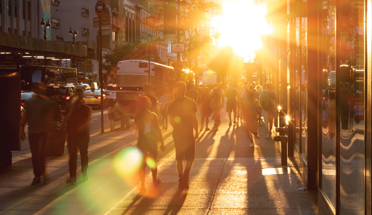 Perspective shot of a busy street lit up by the sunset.
