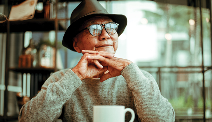 Elderly man with coffee cup