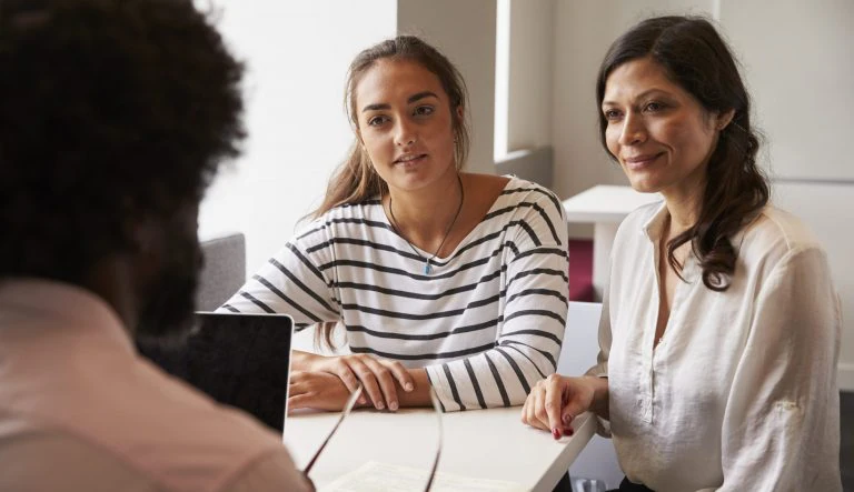 Mother And Daughter Meeting With Male Teacher