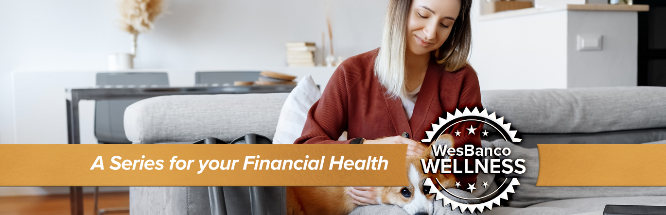 Woman in a cast sits on couch with her dog