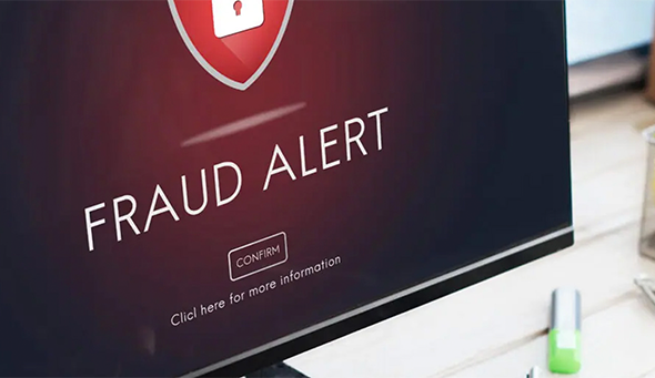 Fraud Alert Caution message on a desktop computer