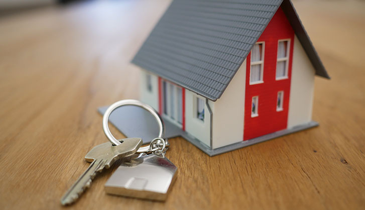 Small toy model of a house with a key next to it