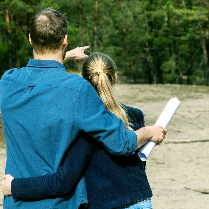 Couple surveying land where they will build their new house.