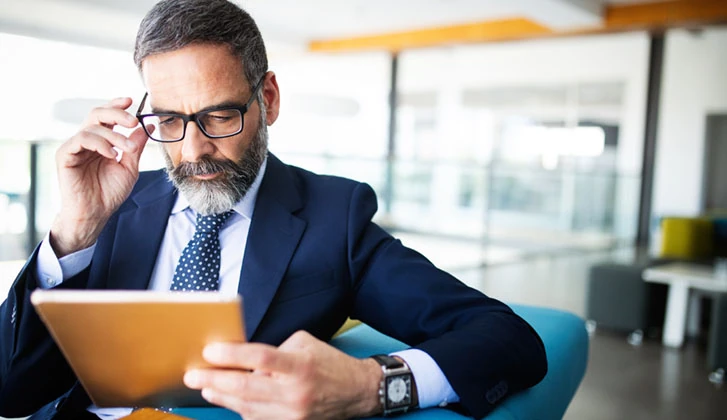 Thinking financial advisor businessman working at office.