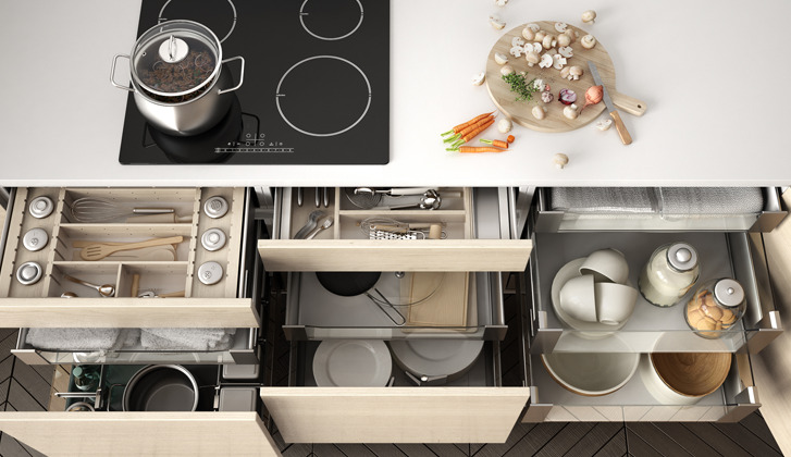 modern stovetop and opened drawers all organized neatly