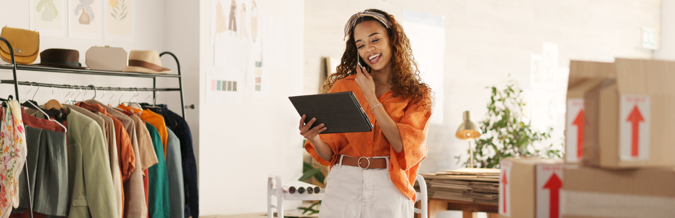 Business woman with tablet in clothing store.