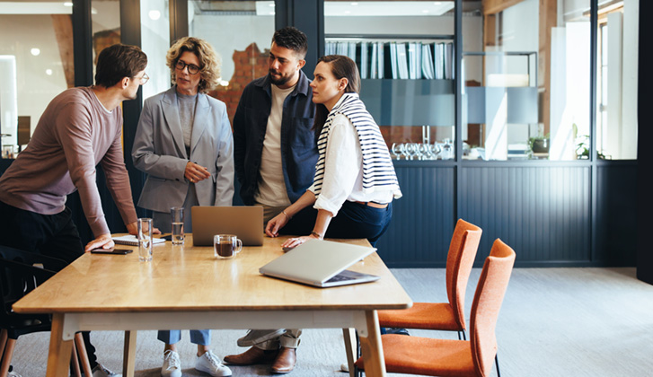 Design professionals having a meeting in an office. Group of business people discussing a project in a boardroom. Teamwork and collaboration in a modern workplace.