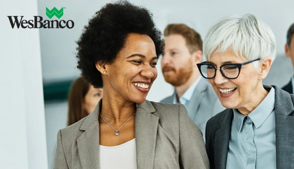 Group of young and senior business people walking toghether and having a meeting in the office. Teamwork and success concept