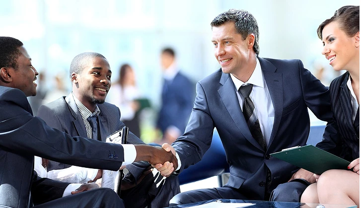 Business men and woman shaking hands