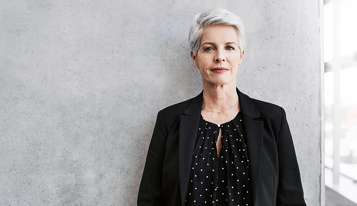 Silver-haired woman in business attire