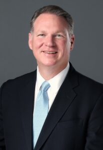 Headshot of Nathan Jones against a grey background