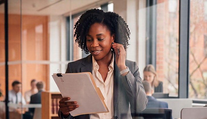 A women in an office looking at some documents